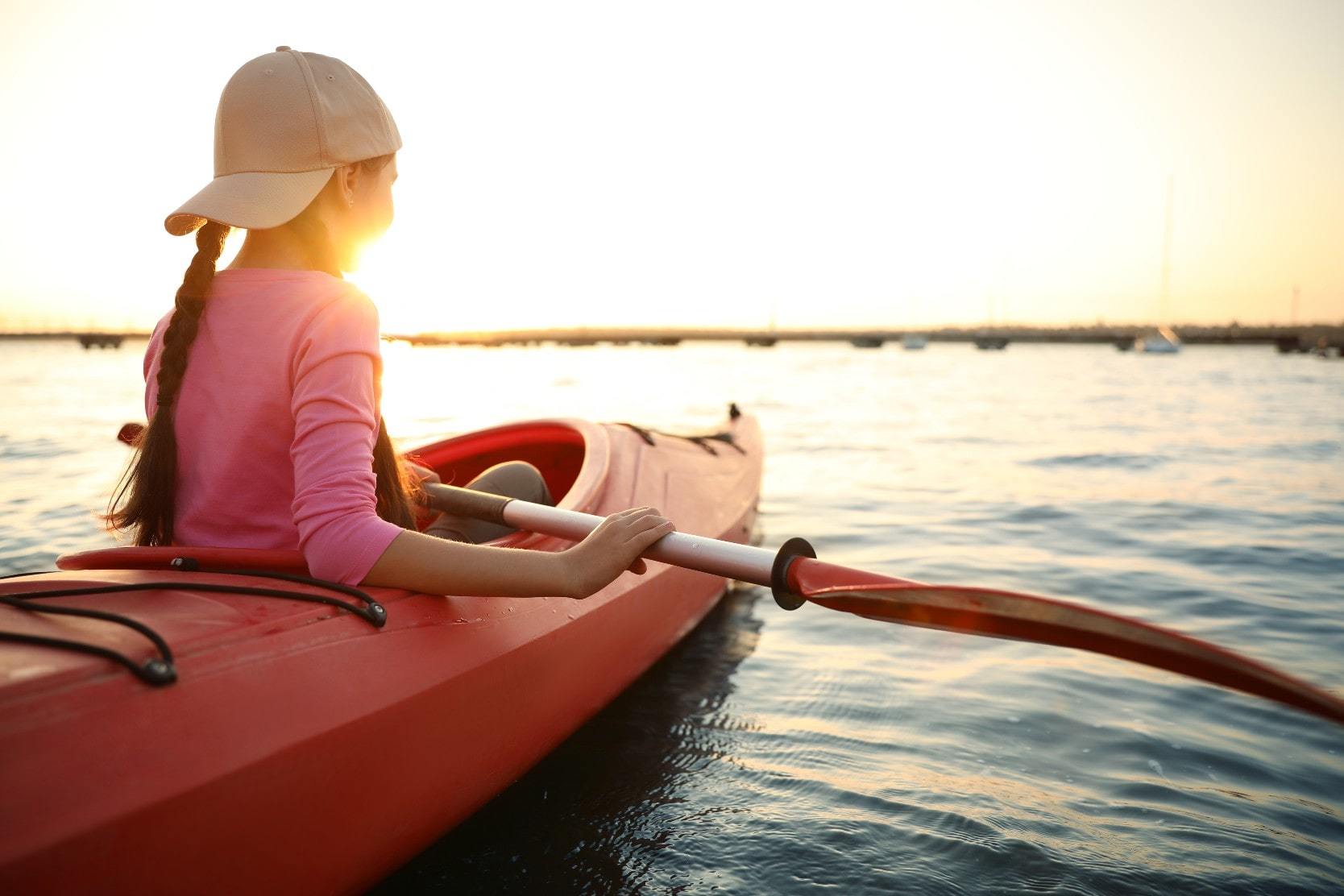 Girl paddling in a kayak on a Lake in Wisconsin